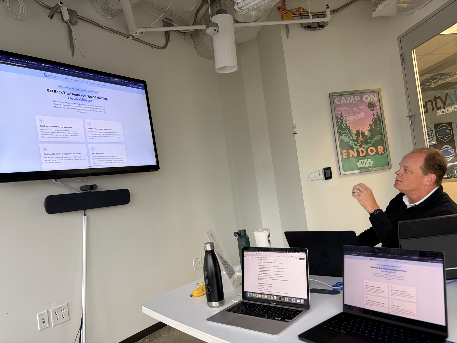 Cohort 1 student presenting the product he built and deployed on the classroom screen